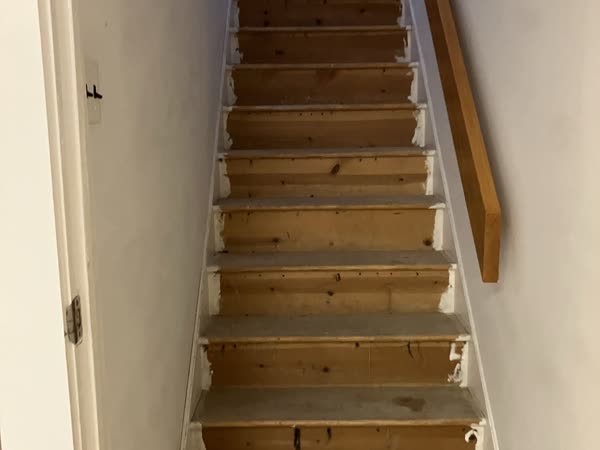 Worn wooden staircase treads before restoration