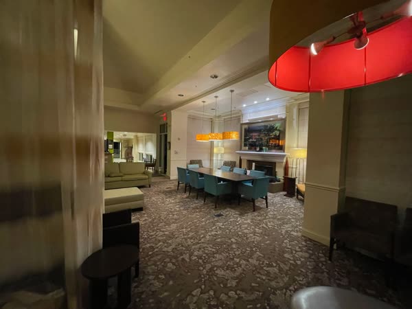 Patterned carpet installation in a hotel lobby by the fireplace