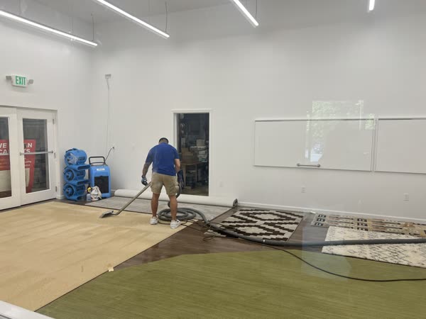 Technician rolling a freshly cleaned area rug at our facility