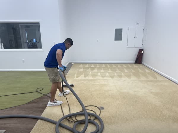 Royalty Carpet technician cleaning carpet with a hot water extraction wand