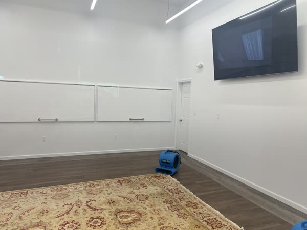 Air movers drying a room after water damage