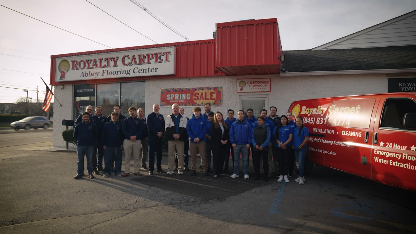 The Royalty Carpet & Flooring team outside the Wappingers Falls showroom with the branded service van
