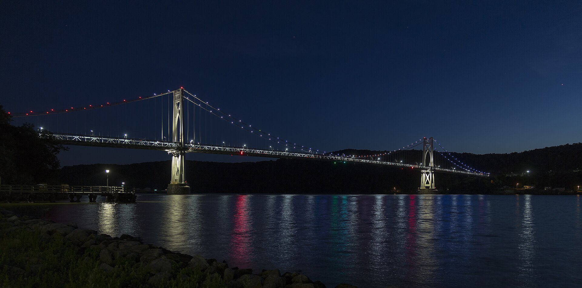 Mid-Hudson Bridge lit up at night spanning the Hudson River at Poughkeepsie NY